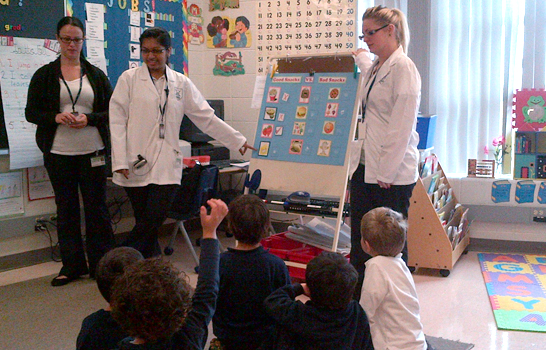 Toronto Dental College Students teaching children dental hygiene